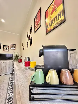 a room with a coffee maker and cups on a table at Casa Esterù -Centro storico di Palermo- in Palermo