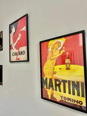 a picture of a woman holding a bottle of wine on a wall at Casa Esterù -Centro storico di Palermo- in Palermo
