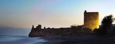 a castle sitting on top of a island in the water at La Dolce Vita in Campofelice di Roccella