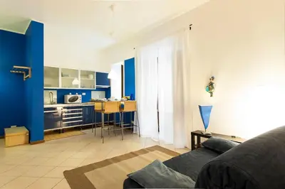 a living room with a couch and a kitchen at Al Vicolo Palermo in Palermo