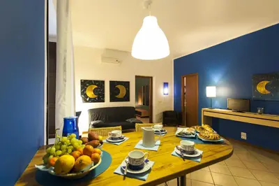 a living room with a dining room table and chairs at Al Vicolo Palermo in Palermo