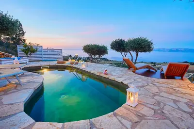 a swimming pool with a patio and chairs in a backyard at Villa Brezza Marina - Scopello-Villas in Scopello