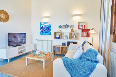 a living room with a white couch and a table at Villa Brezza Marina - Scopello-Villas in Scopello