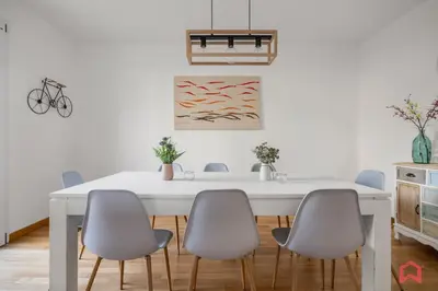 a white dining room with a white table and six chairs at Villa with Sea view Private Pool in Terrasini