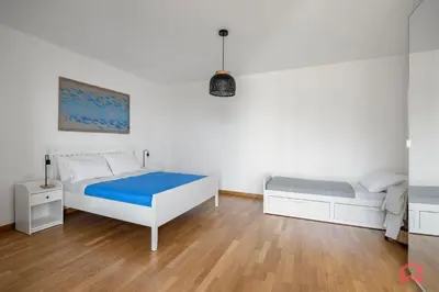 a bedroom with two beds and a wooden floor at Villa with Sea view Private Pool in Terrasini
