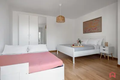 a white bedroom with a bed and a table at Villa with Sea view Private Pool in Terrasini