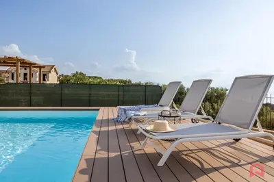 two lounge chairs on a deck next to a swimming pool at Villa with Sea view Private Pool in Terrasini