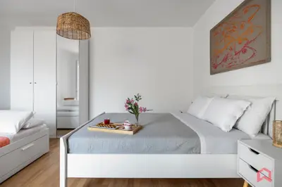 a bedroom with a bed with a tray of flowers on it at Villa with Sea view Private Pool in Terrasini