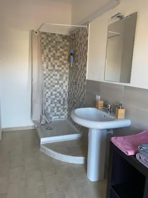 a bathroom with a white sink and a shower at La Casa dell'Aviatore in Boccadifalco