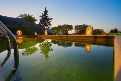 a reflection of a house in a body of water at Villa Desirée - Scopello-Villas in Scopello
