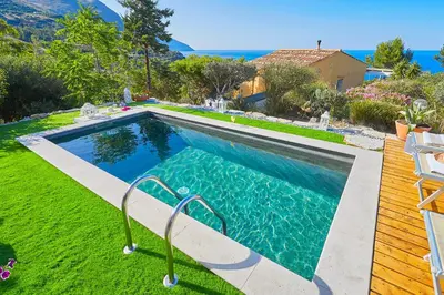 a swimming pool in the backyard of a house at Villa Desirée - Scopello-Villas in Scopello