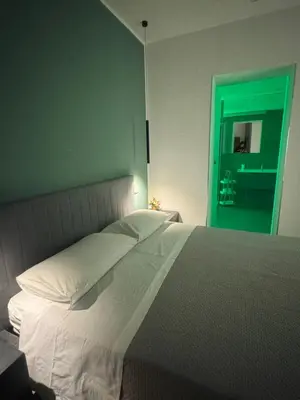 a shower with a glass door with a green ceiling at Luxury Rooms Soraja in Palermo