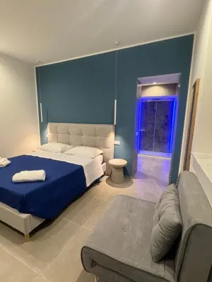 a shower with a blue light in a bathroom at Luxury Rooms Soraja in Palermo