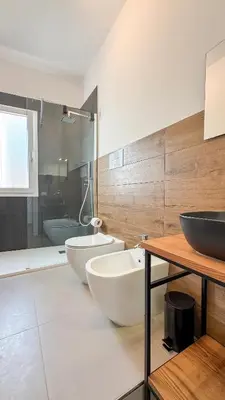 a bathroom with two sinks and a large mirror at Tevergad Premium Rooms in Terrasini