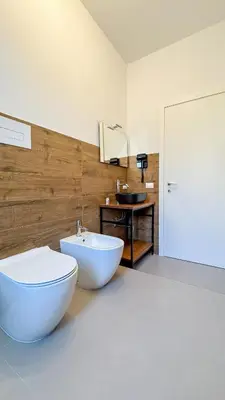 a bathroom with a white tub and a sink at Tevergad Premium Rooms in Terrasini
