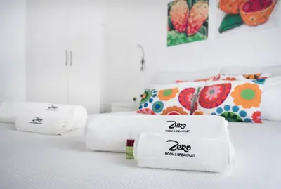two towels sitting on a bed in a room at Room & Breakfast Zero in Palermo