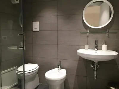 a bathroom with a toilet and a sink and a mirror at Room & Breakfast Zero in Palermo