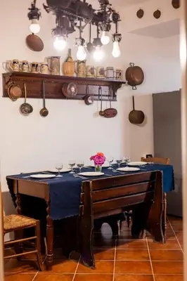 a dining room with a table with a blue table cloth at Villa Carmen in Mandra Capreria