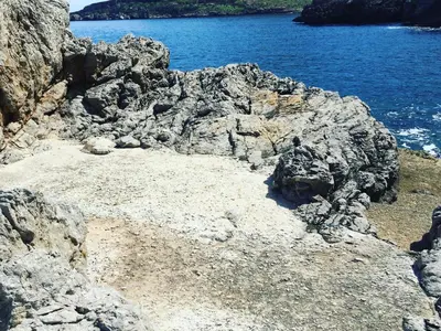 a rocky shore with the ocean and blue water at Il Casale San Vito in San Vito lo Capo