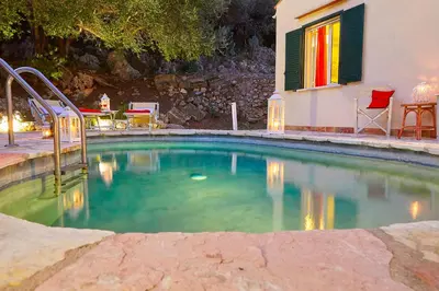a swimming pool in a yard with a house at Villa Rosa Dei Venti - Scopello-Villas in Scopello