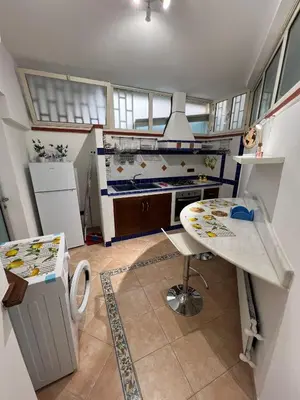 a kitchen with a table and a counter in it at Mondello Tolomea guest house in Mondello