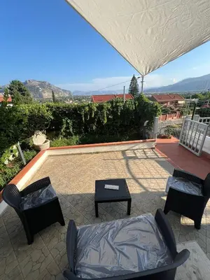 a patio with chairs and a couch and a table at Mondello Tolomea guest house in Mondello