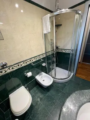 a bathroom with a toilet and a shower and a sink at Mondello Tolomea guest house in Mondello