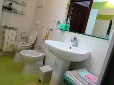a bathroom with a sink and a toilet and a mirror at Appartamento Blu in Palermo
