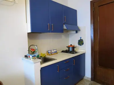 a kitchen with blue cabinets and a sink at Appartamento Blu in Palermo