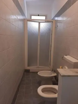a bathroom with a shower and a toilet and a sink at Casa Vacanze Anthea Carini in Carini