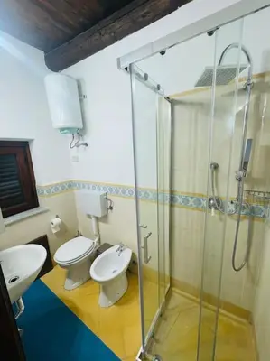 a bathroom with two toilets and a shower at Biscottari's home in Palermo