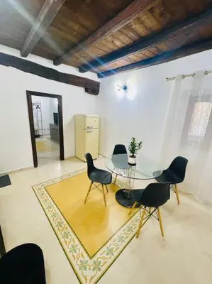 a dining room with a glass table and chairs at Biscottari's home in Palermo