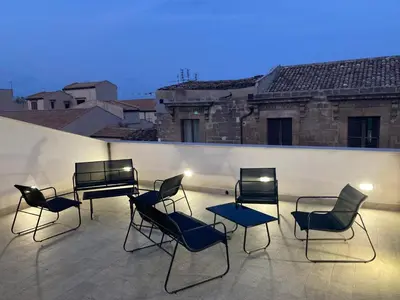 a group of chairs and a piano on a rooftop at B&B Garibaldi in Palermo