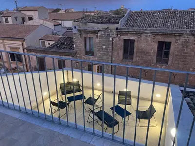 a group of chairs and tables on a balcony at B&B Garibaldi in Palermo