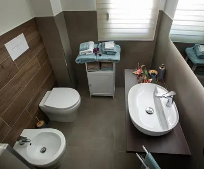 a bathroom with a sink and a toilet at Senza Pensieri Holiday Home in Balestrate
