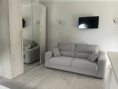 a living room with a couch and a mirror at Villa Nunziatella Badia in Trappeto