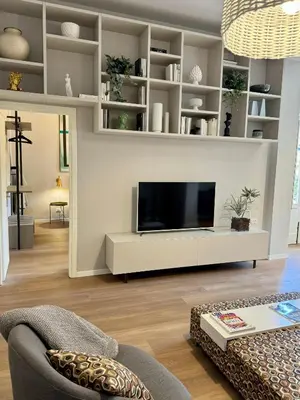 a living room with a flat screen tv on a wall at YourLife Suite1 - Deliziosa casa con terrazzino in Palermo