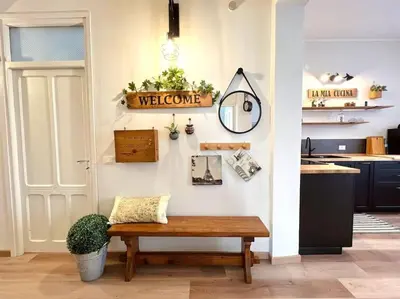 a room with a bench and a welcome sign on a wall at Civico 88 in Calatafimi