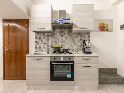 a kitchen with a stove top oven in a room at La Casetta di Mari by Holiday World in Villabate