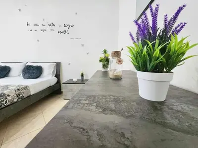 a room with a table with purple plants on it at Bay View Wi-Fi-Vista Mare-Free Parking in Carini