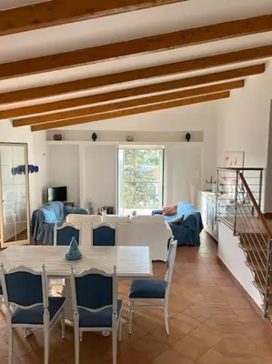 a living room with a table and chairs at traversa 8, aeroporto in Cinisi