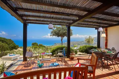 a patio with a view of the ocean at Villa Conchiglia - Scopello-Villas in Scopello
