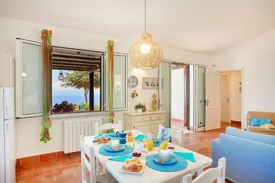 a living room with a table with food on it at Villa Conchiglia - Scopello-Villas in Scopello