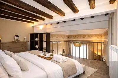 a bedroom with a bed with two night stands and two lamps at Le Quattro Stagioni - Apartments in Palermo