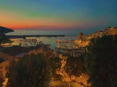 a view of a city with a harbor at sunset at Casa il Sole Casevacanze Ferienwohnung Daniele Furco in Castellammare del Golfo