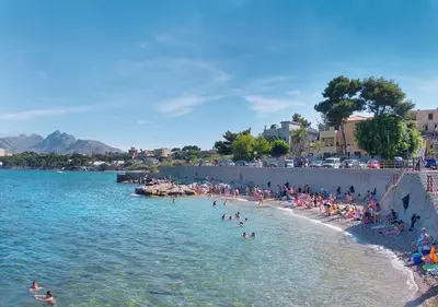 a group of people on a beach in the water at Solemar Sicilia - Casa Emma in Porticello