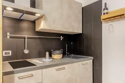 a kitchen with a sink and a counter top at Prospettiva Ballarò - Sopra il mercato in Palermo