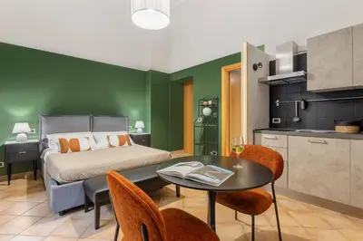 a bedroom with a bed and a table and chairs at Prospettiva Ballarò - Sopra il mercato in Palermo