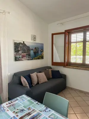 a living room with a couch and a table at Cocciu D'amuri Home - Scopello in Scopello