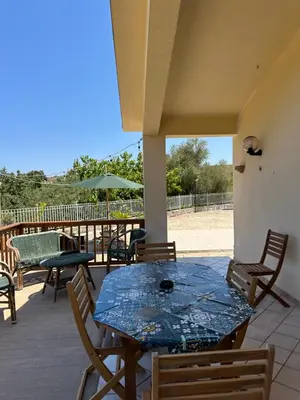 a blue table and chairs on a patio at Cocciu D'amuri Home - Scopello in Scopello